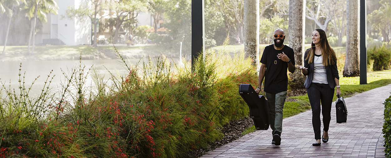 Two students walking to class at the University of Miami Coral Gables campus